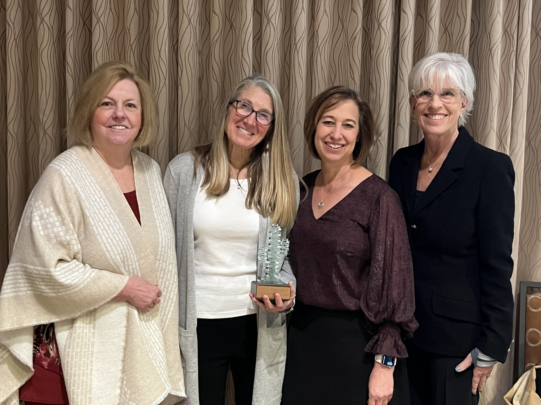 We are champion four women standing for picture at an event